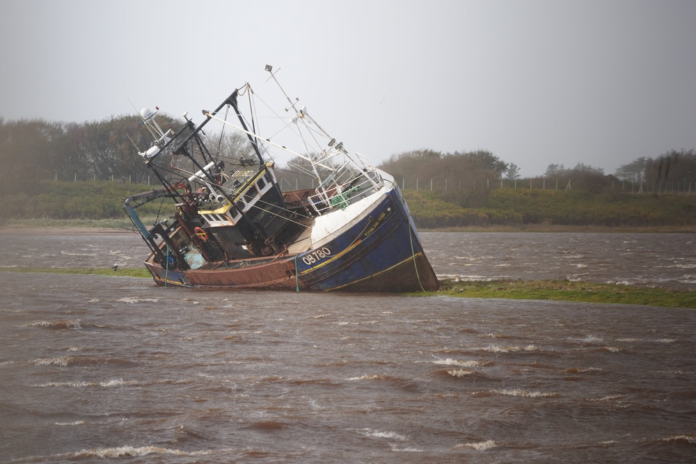 A fishing boat is stranded at Irvine Harbour in North Ayrshire after coming loose from its moorings during Storm Boelo (Jane Barlow/PA) (PA Wire)