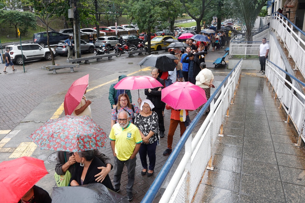 Voters wait in line before polls open in Brazil (Getty)