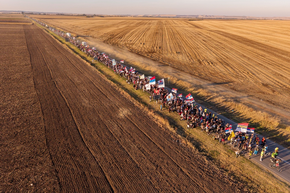 A drone view shows students from Novi Sad walking along a road through the fields on their way to Belgrade near the town of Indjija, Serbia. (Reuters)
