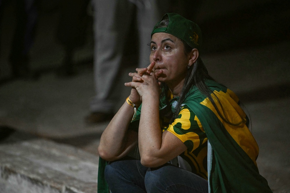 A supporter of Brazil's right-wing Senator and Liberal Party (PL) presidential candidate Flavio Bolsonaro reacts while watching the results (AFP/Getty)