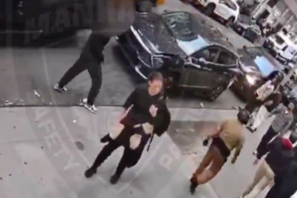 A woman is seen loitering in the street moments before the attack (Manhattan Shomrim)
