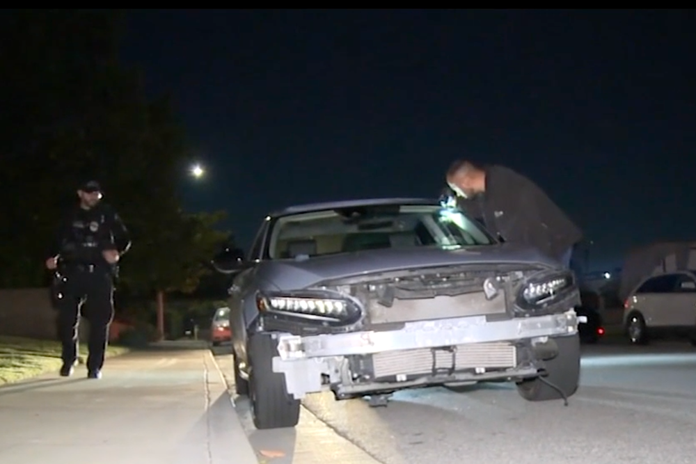 Detectives examine a damaged car thought to have been involved in the deadly collision in Montclair in which a group of Halloween cyclists were hit by a suspected DUI driver (ABC 7)
