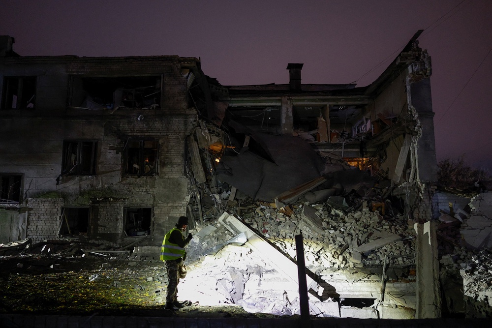 A police officer inspects the site of a food production facility hit by a Russian missile strike (Reuters)