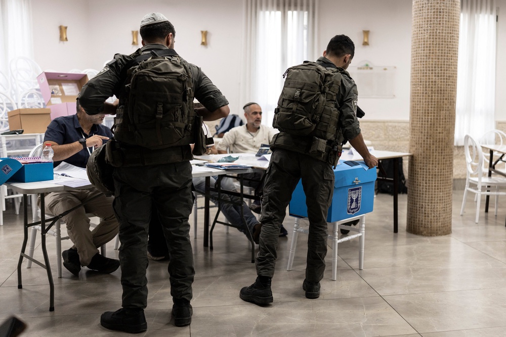 Israeli border policemen cast their ballots at a polling station in the occupied West Bank city of Hebron on October 27 (AFP/Getty)