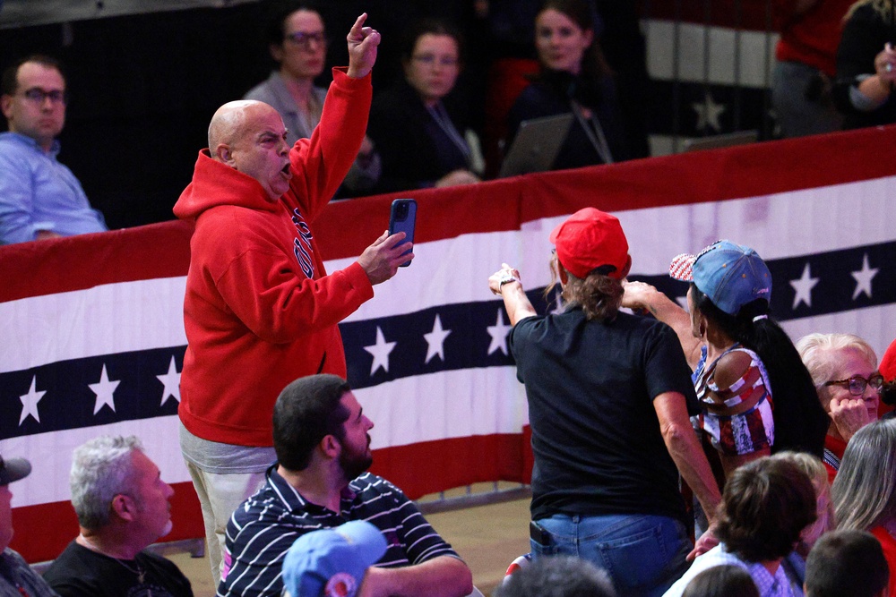 The protester was escorted away as the crowd chanted 'USA' (Getty)
