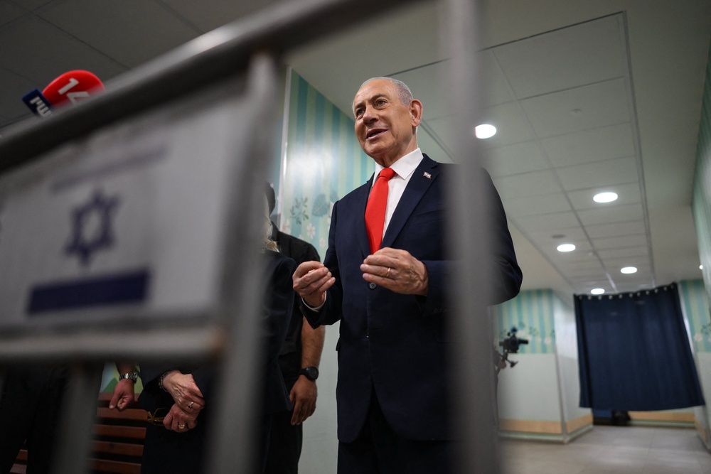 Benjamin Netanyahu speaks to the media after voting at a polling station in Jerusalem (AFP/Getty)