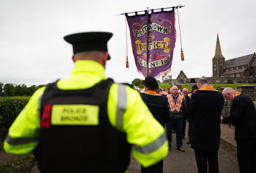 Orangemen make their way from Drumcree Church as police form a barricade to prevent them entering the Garvaghy Road during the stand-off (Brian Lawless/PA) (PA Wire)