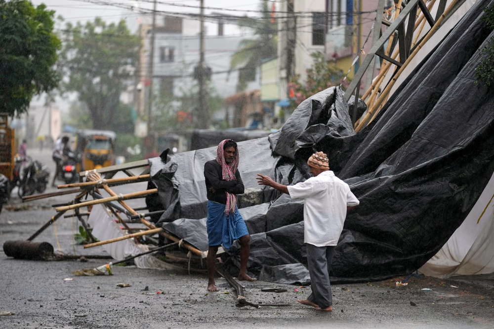 A man walks past the destruction caused at Kakinada (AP)