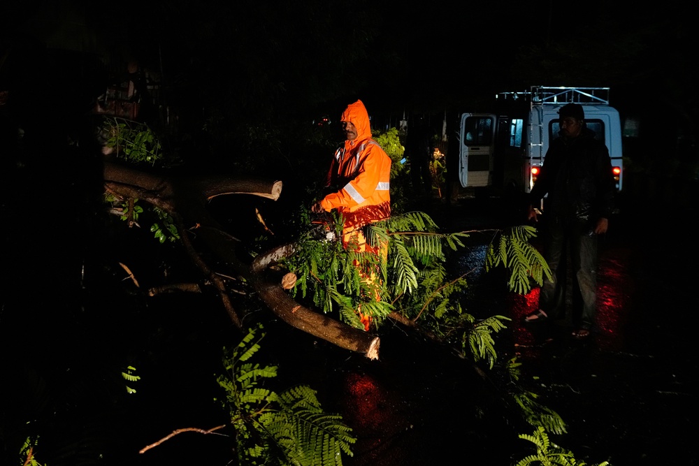 Firefighters clear trees uprooted by rain and strong winds as Cyclone Arnab approaches the Andhra Pradesh coast in Kakinada (AP)