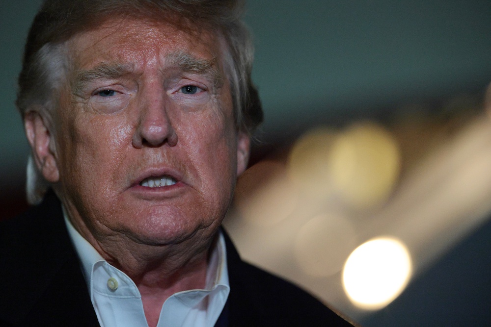 Trump talks to reporters after stepping off Air Force One on October 28 (Getty)