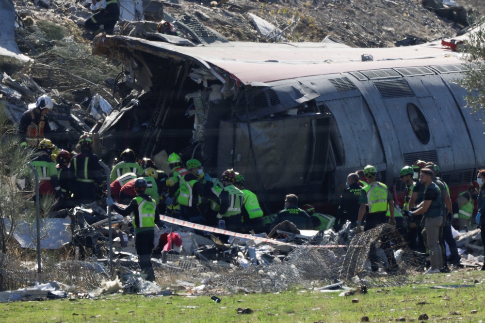 Rescue personnel work at the site of the collision of two high-speed trains between the towns of Mora and Orgaz, near Toledo (Reuters)