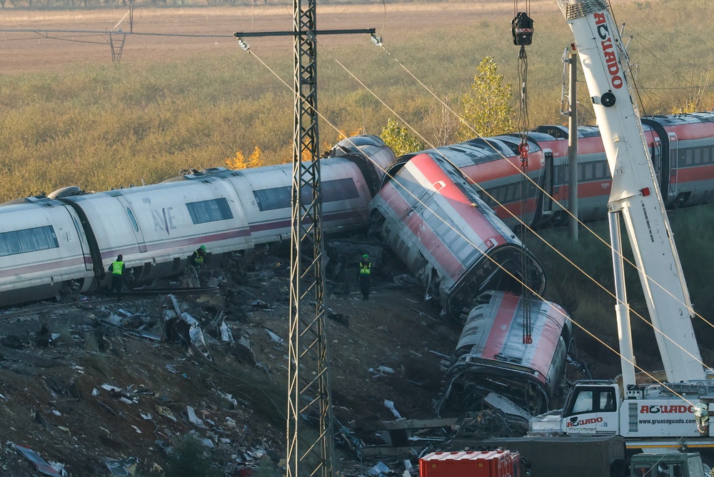 Investigators use heavy machinery to remove damaged carriages from the train crash (AFP/Getty)