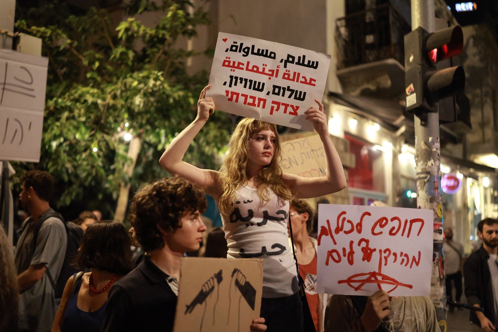 Israeli left-wing activists hold placards during a protest calling for a formation of a government, in Tel Aviv on Wednesday (AFP/Getty)