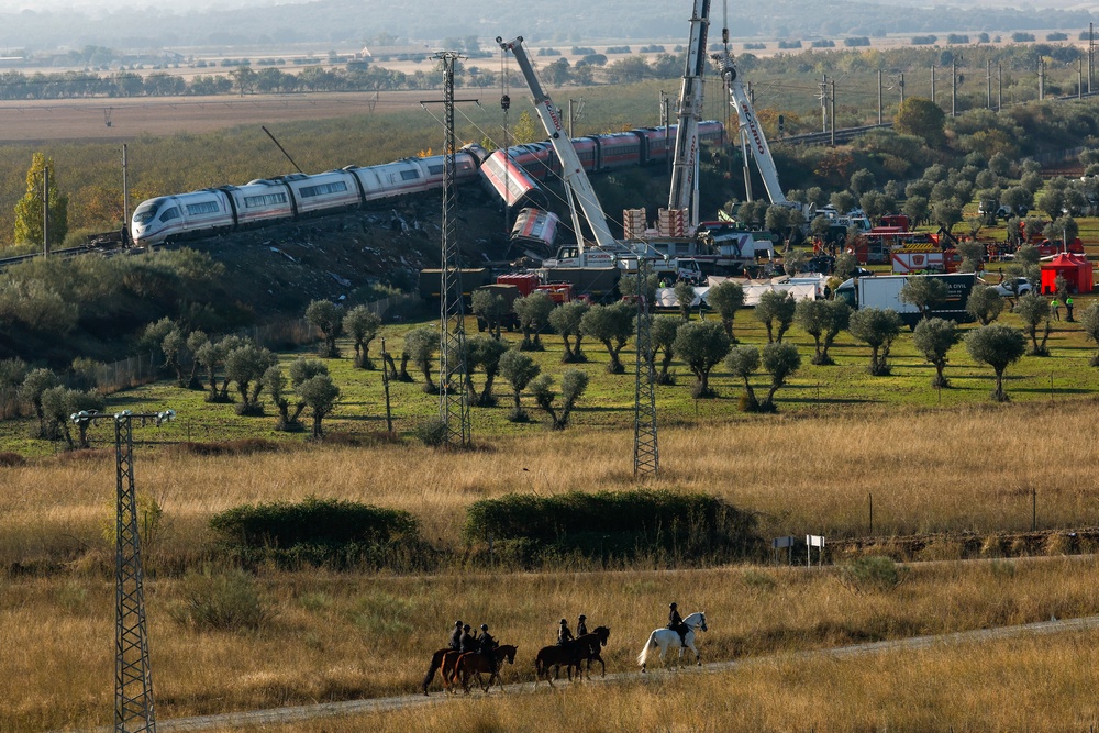 Cranes lifted the wreckage overnight in a search for survivors (AFP/Getty)