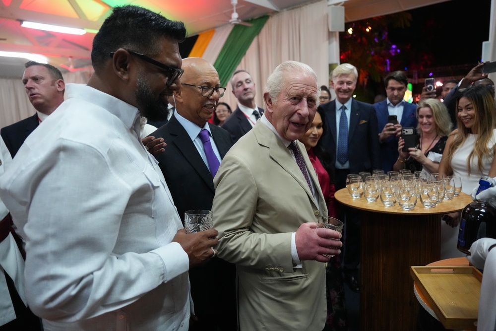 King Charles holds a glass of a specially produced Guyanese rum created in his honour during a state reception at State House in Georgetown, during the royal visit to Guyana (Ben Stanstall/PA) (PA Wire)
