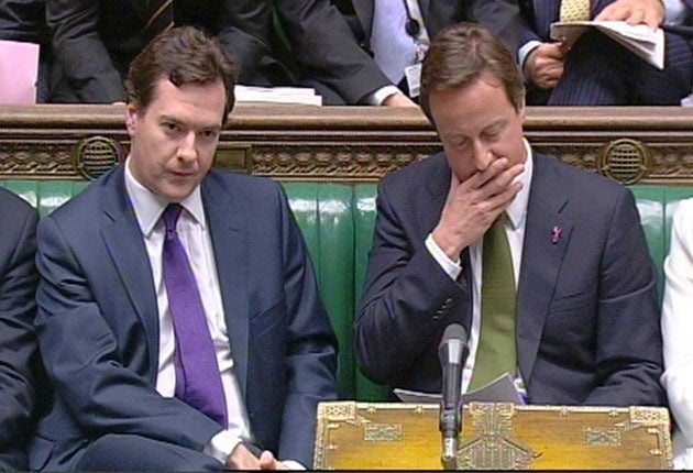 George Osborne with David Cameron in the House of Commons (PA)