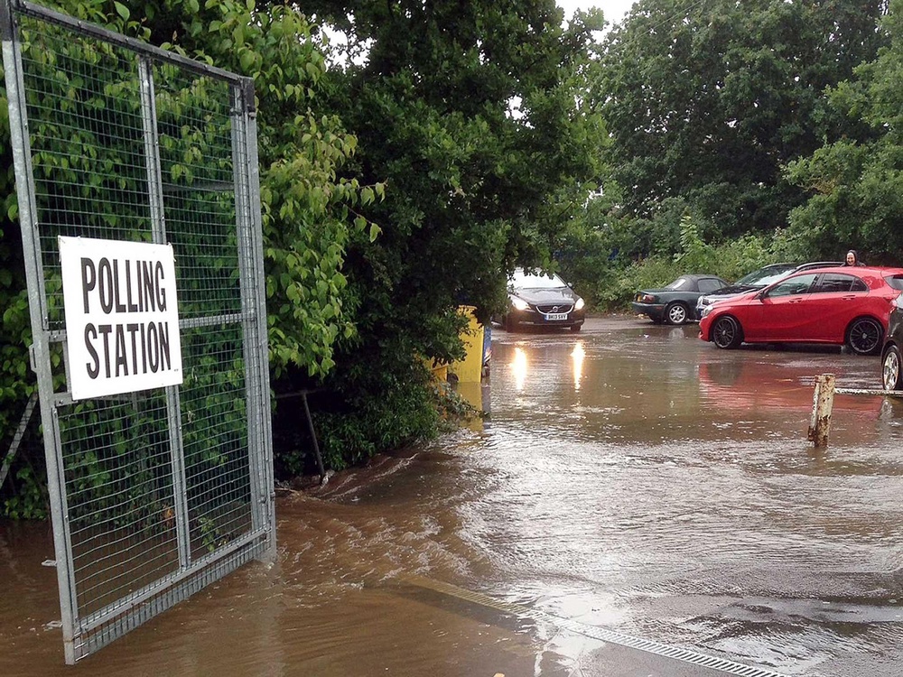 A flooded car park at a polling station in Chessington, south London, after heavy rain (@hjyoungs) (PA)