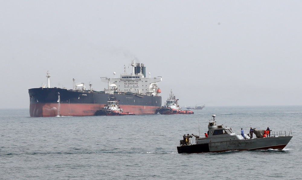An Iranian military boat patrols next to the Artavil oil tanker, off Kharg Island in the Persian Gulf (EPA)