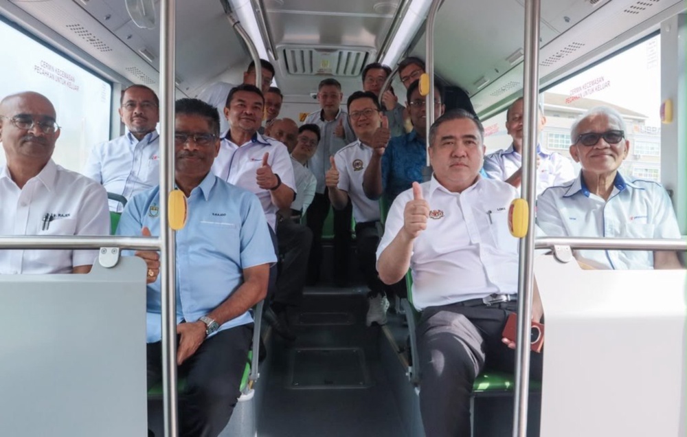 Transport Minister Anthony Loke taking a ride on the electric bus. -- NSTP/AUDREY DERMAWAN