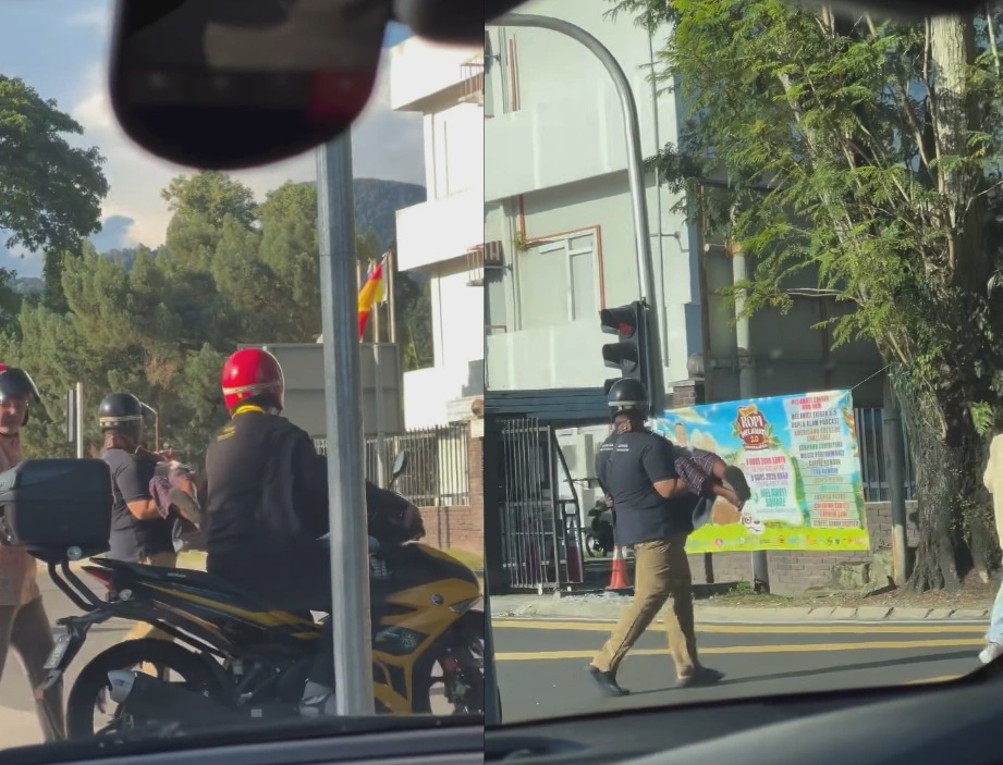 Kind motorcyclist carries elderly woman across busy road in Taman Melawati