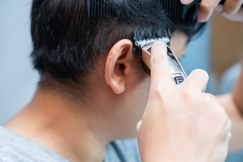 A mullet begins to take shape as the hair around the face is shortened and the nape is left longer.