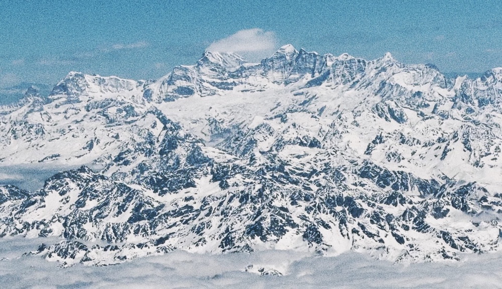 The Himalayan peaks towering over the clouds from our plane