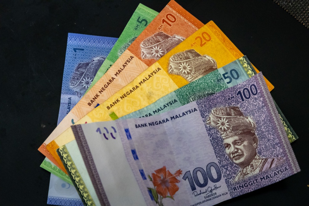 Ringgit slips against US dollar as traders lock in gains
