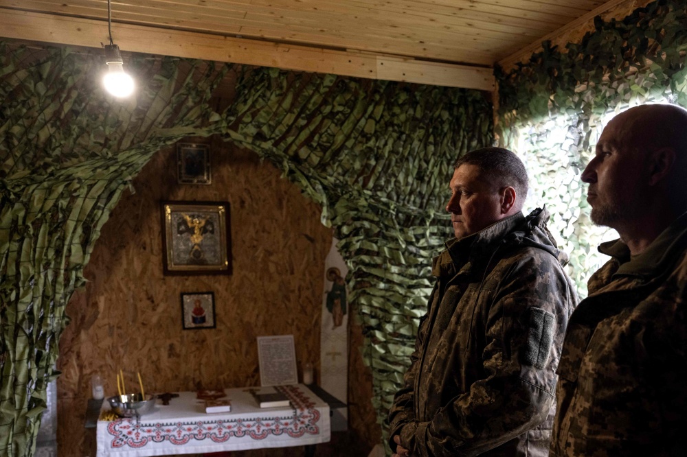 In this handout photograph taken on April 10, 2026 and released on April 11, 2026 by the press service of the 93rd Kholodnyi Yar Separate Mechanized Brigade of the Ukrainian Ground Forces, Ukrainian servicemen attend a religious service in a room turned into a church at an undisclosed location near Sloviansk, Donetsk region, amid the Russian invasion of Ukraine. — Iryna Rybakova/The 93rd Kholodnyi Yar Separate Mechanised Brigade handout/AFP pic 