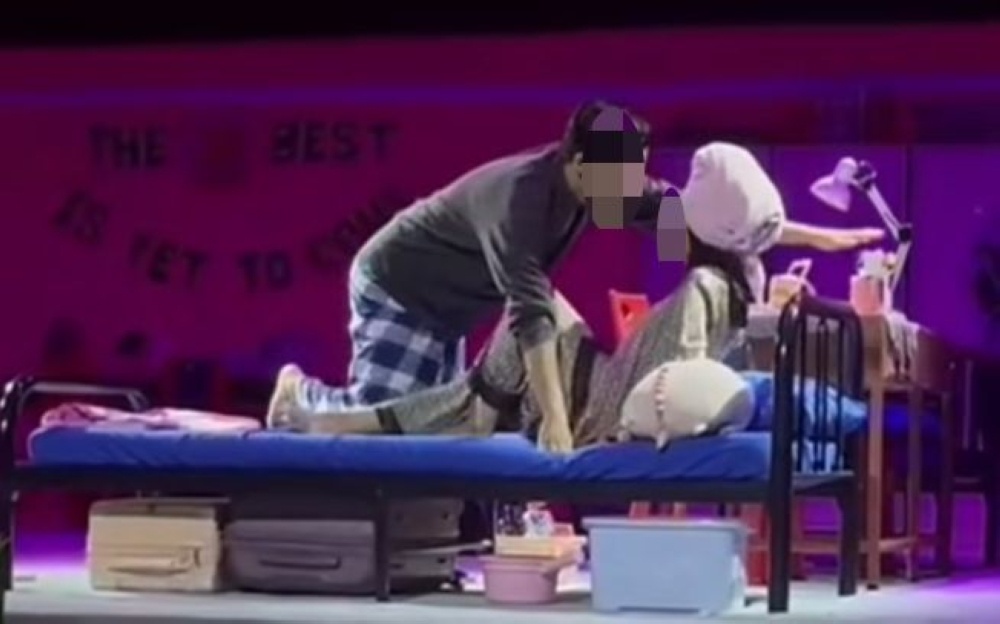 A still shows two performers during the controversial bedroom scene in a theatrical production during Universiti Malaya’s Theatre Carnival in April 2026. — Picture from social media