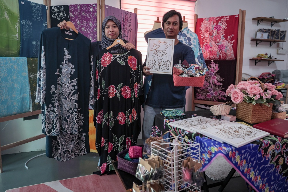 Nadia Mohd Fuzi, 39, and her husband, Haiyat Md Hassim, 47, show some of their batik products at Rumah Batik Sri Wangsa in Mersing, Johor recently. — Bernama pic