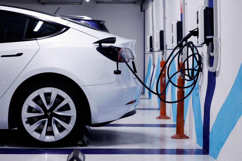 An electric vehicle is plugged into a charging station in Bilbao, Spain February 15, 2023. ― Reuters pic