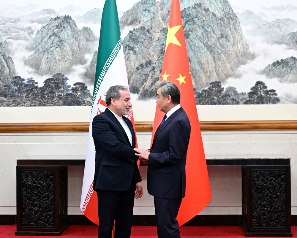 Chinese Foreign Minister Wang Yi and Iranian Foreign Minister Abbas Araqchi shake hands in Beijing, China on May 6, 2026. — Reuters pic