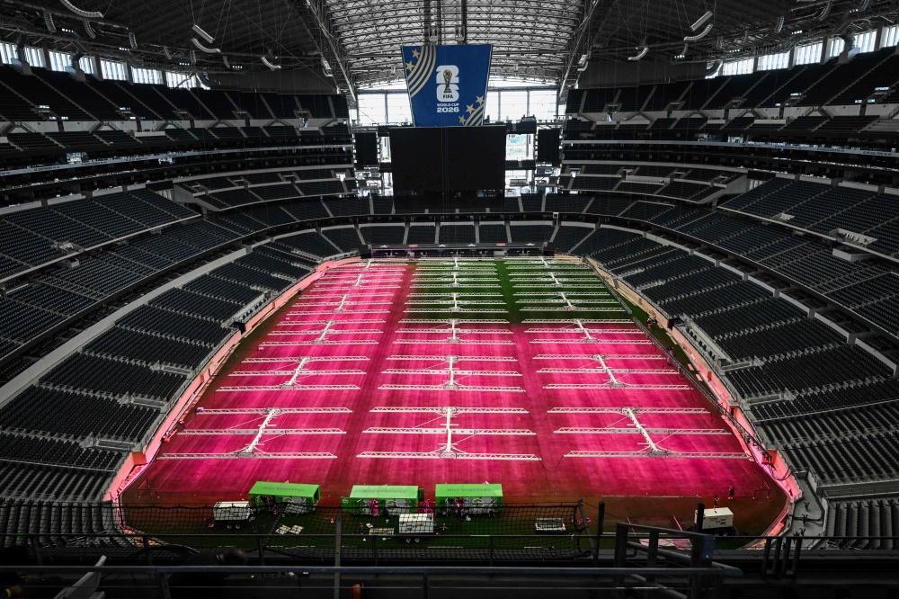 Dallas Stadium (temporarily renamed from AT&T Stadium for the 2026 FIFA World Cup) is seen with purple lights illuminating the field to promote grass growth, in Arlington, Texas, on May 14, 2026. — AFP pic