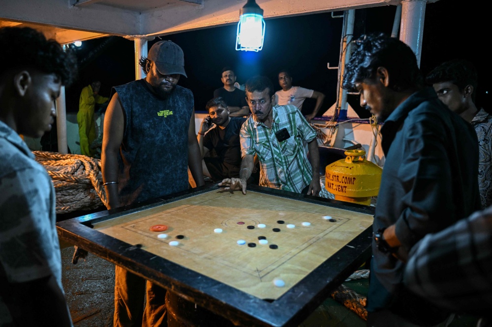 This photograph taken on March 30, 2026 shows passengers playing carrom game on the MV Kalighat vessel plying across the waters of India’s Andaman and Nicobar Islands. — AFP pic 