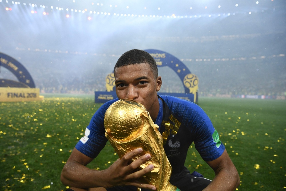 This file picture shows France forward Kylian Mbappe kissing the Fifa World Cup trophy after France defeated Croatia in the 2018 final at the Luzhniki Stadium in Moscow, July 15, 2018. — AFP pic