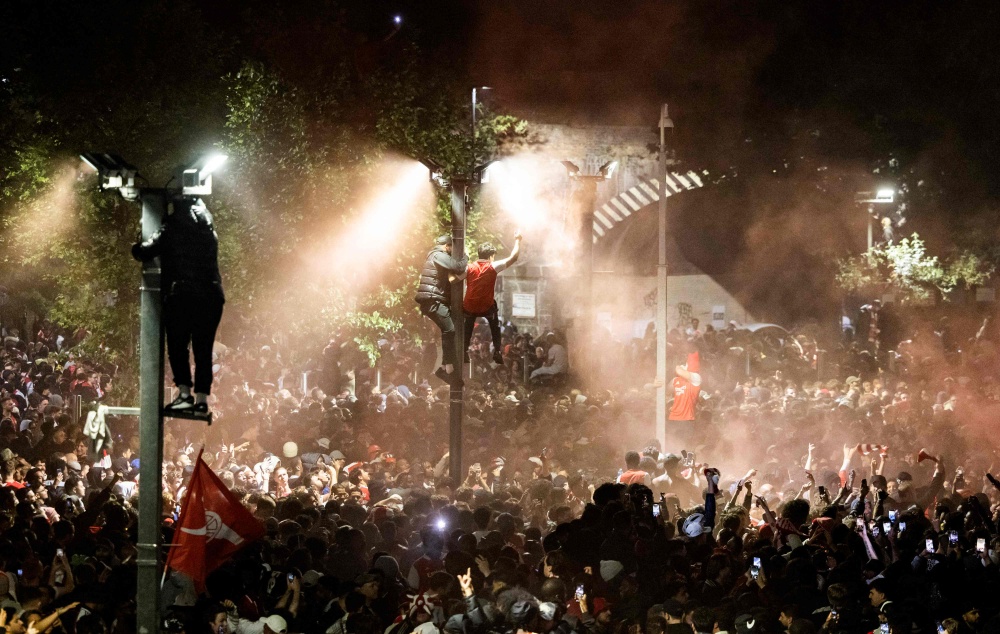 Arsenal fans celebrate their team winning the English Premier League, outside the Emirates Stadium in London on May 20, 2026. — AFP pic