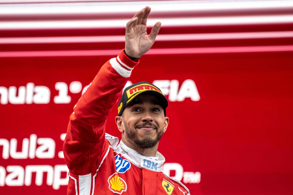 Ferrari’s British driver Lewis Hamilton waves from the podium as he celebrates his second place at the conclusion of the 2026 Formula 1 Grand Prix du Canada at Circuit Gilles-Villeneuve in Montreal, Canada, on May 24, 2026. — AFP pic