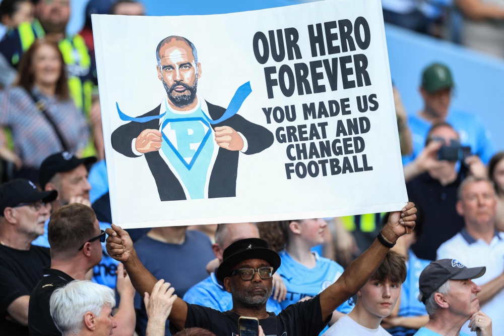 A supporter holds up a sign in honour of Manchester City’s Spanish manager Pep Guardiola during ceremonies to honour those leaving the club, including Guardiola, at the end of the season, following the English Premier League football match between Manchester City and Aston Villa at the Etihad Stadium in Manchester, north west England, on May 24, 2026. — AFP pic