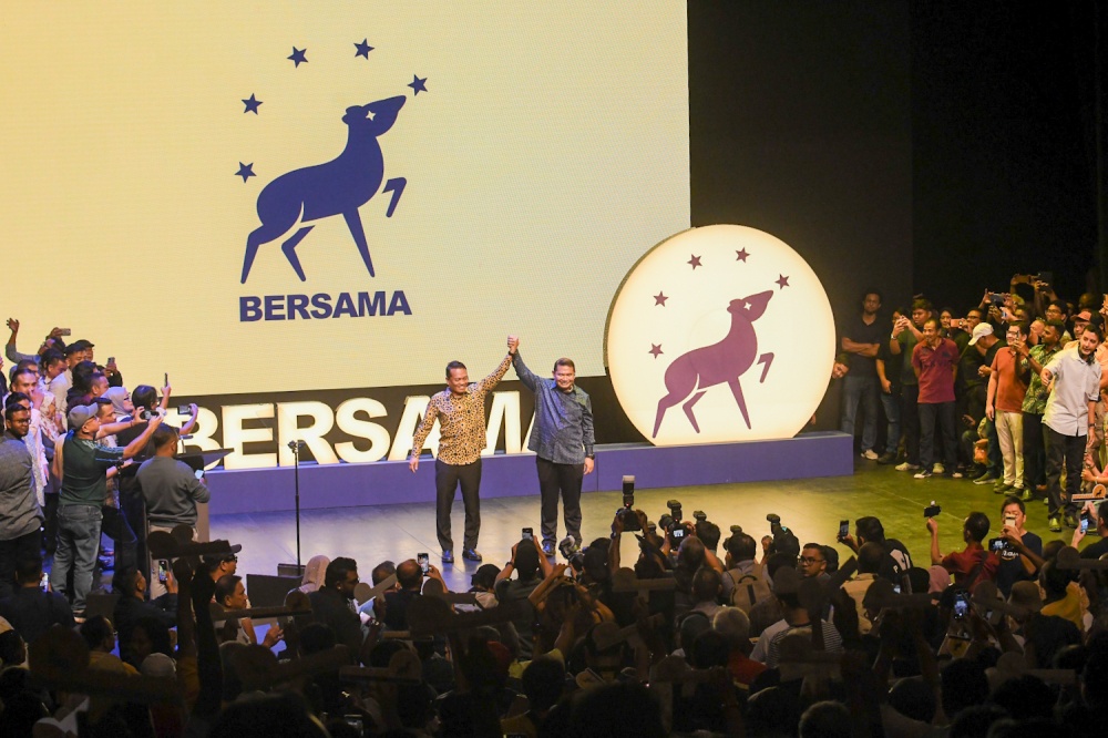 (From left) Nik Nazmi Nik Ahmad and Datuk Seri Rafizi Ramli raise their hands together on stage during the official launch of the new political branding 'BERSAMA' (Together) at the PJ Performing Arts Centre in Petaling Jaya. May 17, 2026—Picture by Raymond Manuel