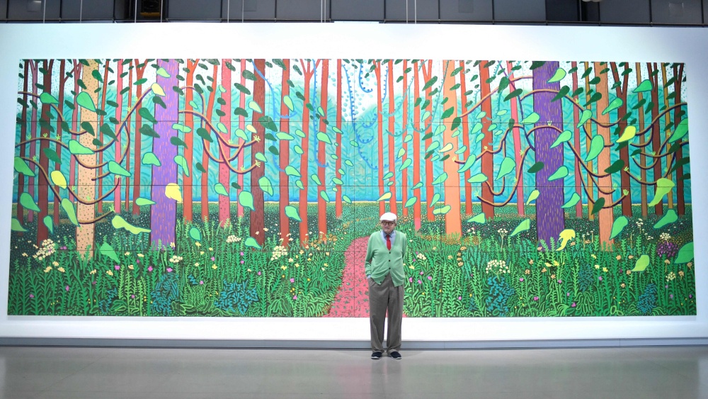 British painter David Hockney poses at the Pompidou Centre in Paris on September 26, 2017 in front of one of his painting ‘The Arrival of Spring in Woldgate, East Yorkshire in 2011’, a work made of an assemblage of various paintings, that he donated to the museum. Hockney, considered one of the most influential and defining figures in contemporary art, whose paintings captured the world in brilliant colour, has died aged 88, his public relations agent announced yesterday. — AFP pic 