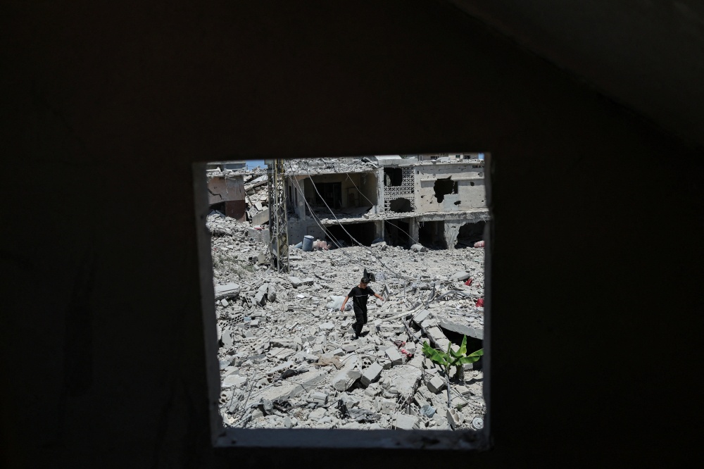 A boy walks among the rubble of a neighborhood completely destroyed by an Israeli airstrike, following the US-Iran deal, in Qlailieh, Tyre district, Lebanon, June 18, 2026. — Reuters pic