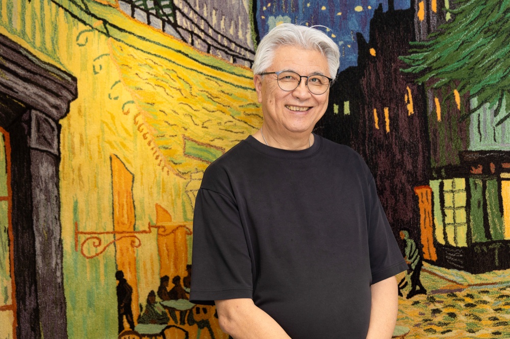 George Ip, the owner and chef of George Private Kitchen, is seen here with a ceiling-to-floor textile hanging of Van Gogh’s Café Terrace at Night, which he has had for about 30 years or so now. — Picture courtesy of Hong Kong Tourism Board