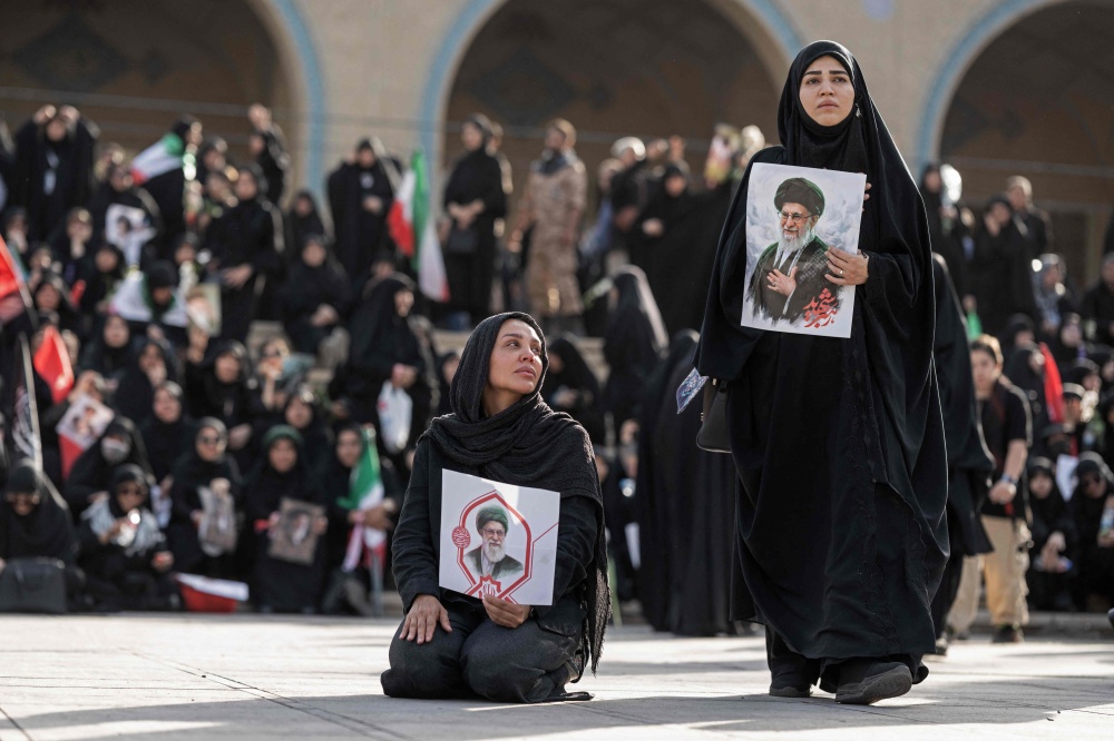 Mourners hold portraits of Iran’s slain supreme leader Ayatollah Ali Khamenei at the start of his funeral ceremonies at the Grand Mosalla in Tehran on July 4, 2026. — AFP pic