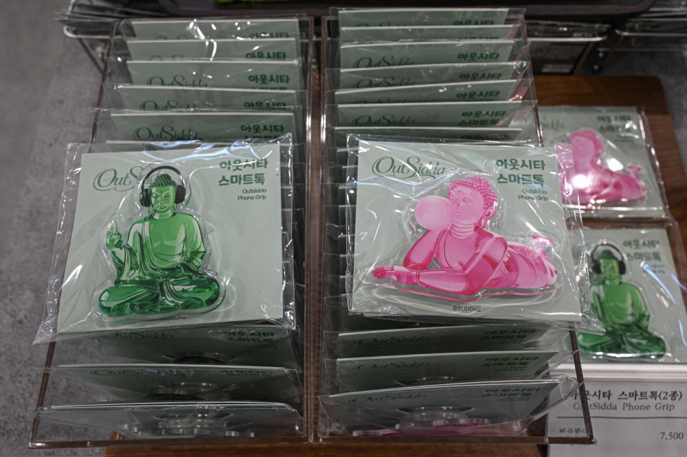 Buddhism-themed phone grips are displayed at a souvenir store in Seoul on July 6, 2026. — AFP pic