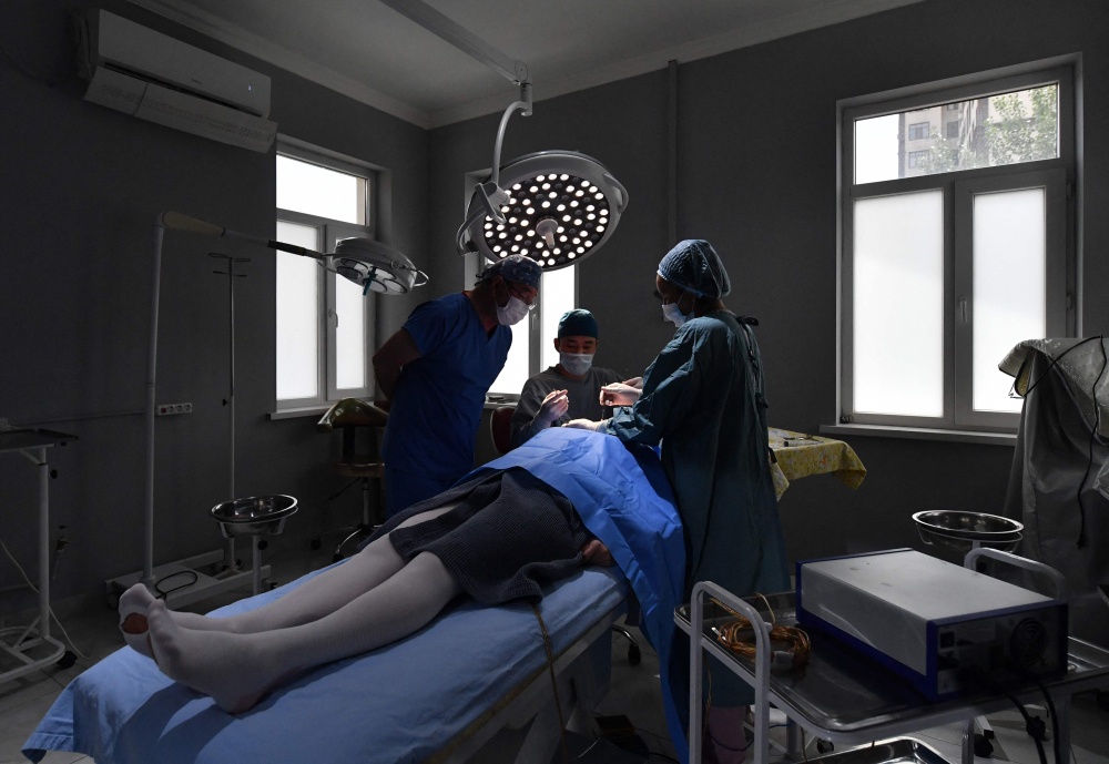 Kyrgyz plastic surgeon Iskender Kachkinbayev oversees a plastic surgery in Bishkek on May 18, 2026. — AFP pic