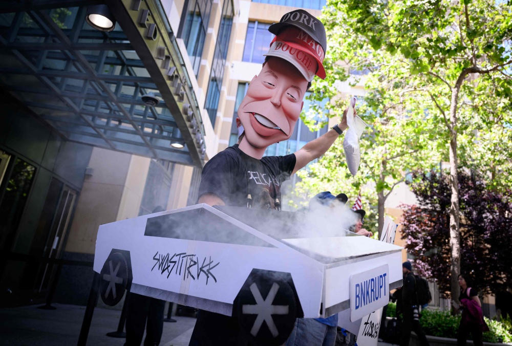 AI protesters chant outside the federal courthouse during proceedings in the trial of Elon Musk against OpenAI in Oakland, California on May 12, 2026. — AFP pic