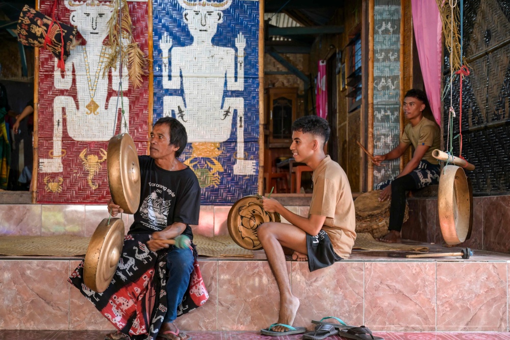 This photo taken on June 26, 2026 shows men playing traditional musical instruments during a marapu funeral ceremony for Dicki Takandjandji, a member of the ‘maramba’ noble class, at Kaburu village at Waingapu in East Sumba, East Nusa Tenggara. — AFP pic