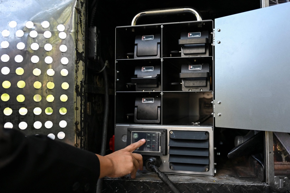 A person checks the batteries of an electric battery powered food cart in Flushing Meadows-Corona Park on July 23, 2026 in New York City. — AFP pic