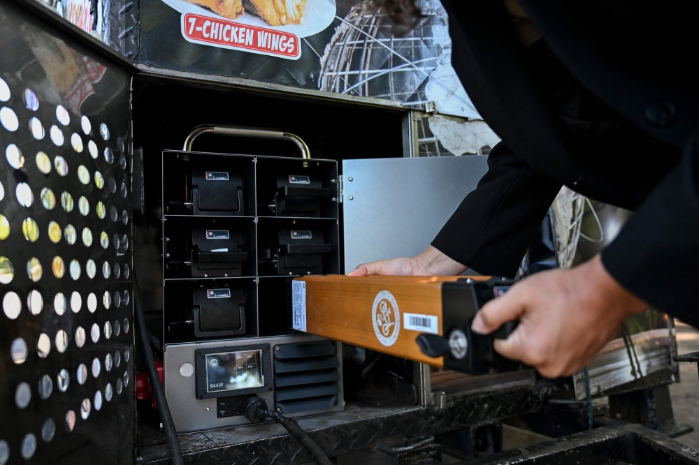 A person pulls out a battery of an electric battery powered food cart in Flushing Meadows-Corona Park on July 23, 2026 in New York City. — AFP pic