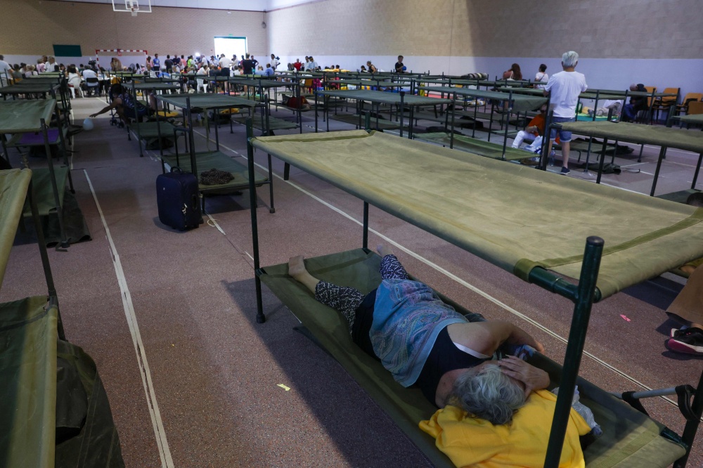 Residents evacuated from a wildfire near San Martin de Valdeiglesias take shelter in a sportshall in Villamanta, west of Madrid July 24, 2026. Local authorities set up emergency shelters in schools and gymnasiums for tourists and residents left wondering what they would return to. — AFP pic